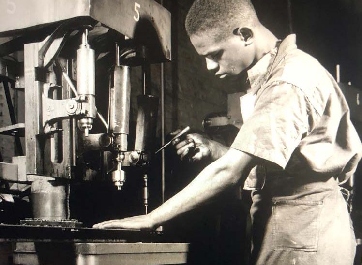 African American at factory machine